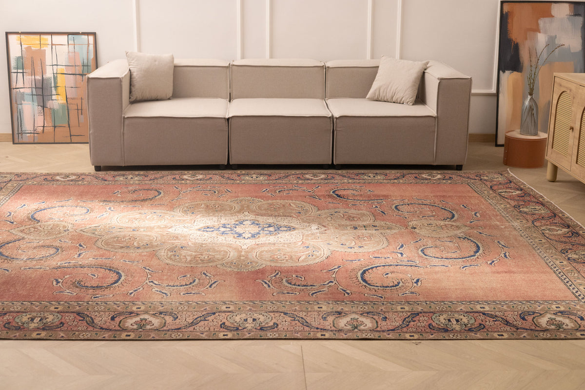 Oversized 9x12 Persian-style wool and cotton rug with brown floral patterns in a traditional farmhouse living room.