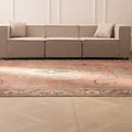 Oversized 9.4x12.6 ft wool and cotton Persian-style rug with brown floral patterns in a traditional farmhouse living room.