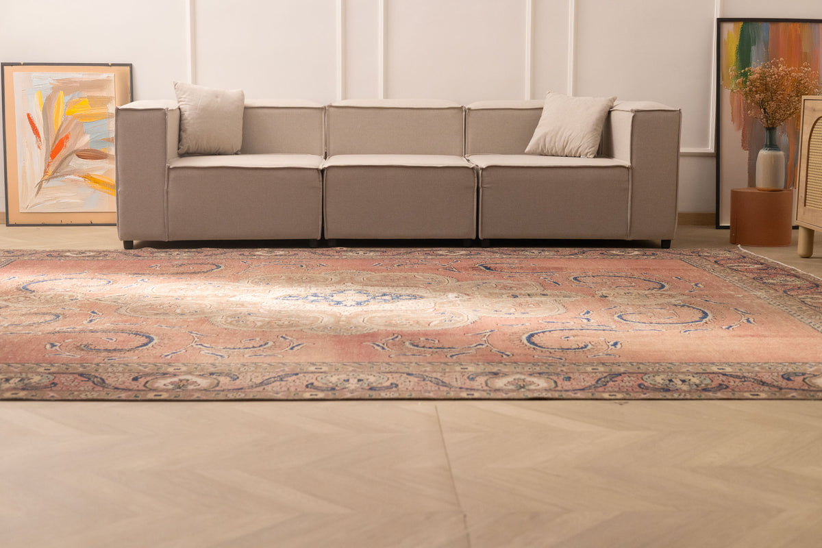 Oversized 9.4x12.6 ft wool and cotton Persian-style rug with brown floral patterns in a traditional farmhouse living room.