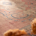 Oversized Persian-style wool and cotton area rug featuring brown and blue floral patterns in a traditional farmhouse design.