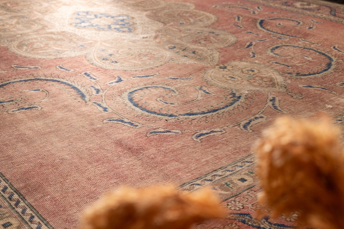 Oversized Persian-style wool and cotton area rug featuring brown and blue floral patterns in a traditional farmhouse design.
