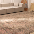 Oversized beige Persian-style wool and cotton area rug with elegant floral motifs in a traditional living room.