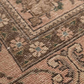 Handmade wool and cotton Persian area rug featuring beige floral patterns and traditional motifs in a low pile texture.