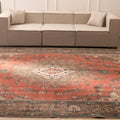 Oversized red Persian-style wool and cotton area rug featuring traditional floral motifs and intricate bohemian patterns.