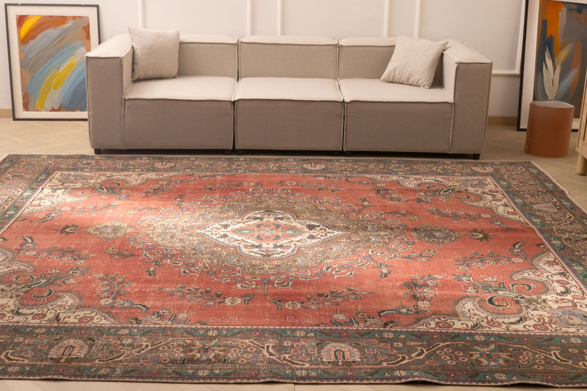 Oversized red Persian-style wool and cotton area rug featuring traditional floral motifs and intricate bohemian patterns.