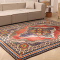 Oversized 7x10 Persian-style wool and cotton area rug featuring a red and navy floral maximalist pattern in a living room.