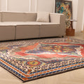 Oversized 7.3 x 10 ft wool and cotton Persian-style area rug featuring a red and navy floral maximalist pattern.