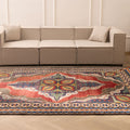 Oversized 7.3x10 ft Persian-style wool and cotton area rug featuring vibrant red and navy floral patterns in a traditional design.