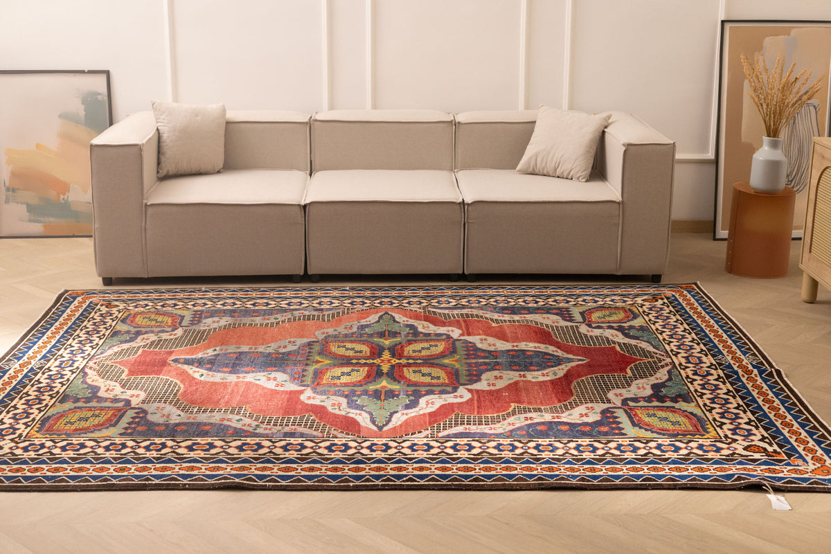 Oversized 7.3x10 ft Persian-style wool and cotton area rug featuring vibrant red and navy floral patterns in a traditional design.