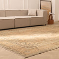 Oversized beige and brown Persian-style wool-cotton rug with traditional floral patterns in a living room.