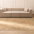 Oversized beige and brown Persian-style wool and cotton area rug with traditional floral patterns in a modern living room.