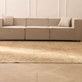 Oversized beige and brown Persian-style wool-cotton rug with traditional floral patterns in a modern living room.