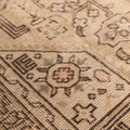 Beige Persian-style wool and cotton rug with intricate geometric floral motifs and a low-pile traditional design.