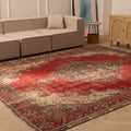 Oversized red Persian-style area rug with intricate floral patterns, crafted from a wool and cotton blend in a living room.