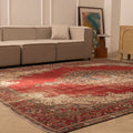 Oversized red Persian-style wool and cotton area rug with intricate floral patterns in a modern living room.