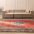Oversized red and navy Persian-style wool and cotton area rug with intricate floral patterns in a modern living room.