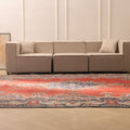 Oversized red and navy Persian-style wool and cotton area rug with traditional floral patterns in a living room.