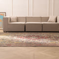 Oversized Persian-style wool and cotton rug featuring intricate red and floral patterns in a bohemian living room.
