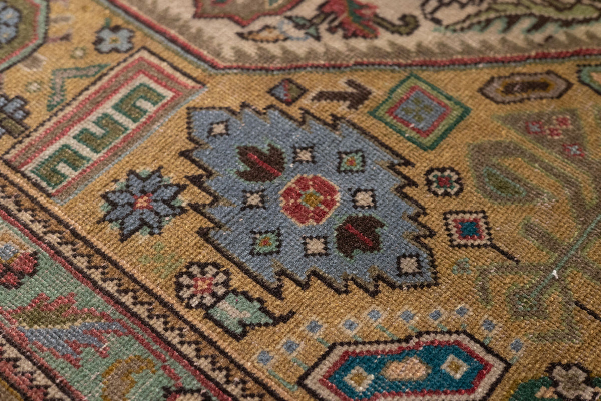 Handmade wool and cotton Persian-style area rug with intricate floral motifs, maximalist patterns, and rich, colorful details.