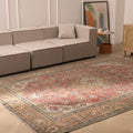 Oversized 7.7x11 ft Persian-style wool and cotton rug featuring traditional red and brown floral patterns in a living room.