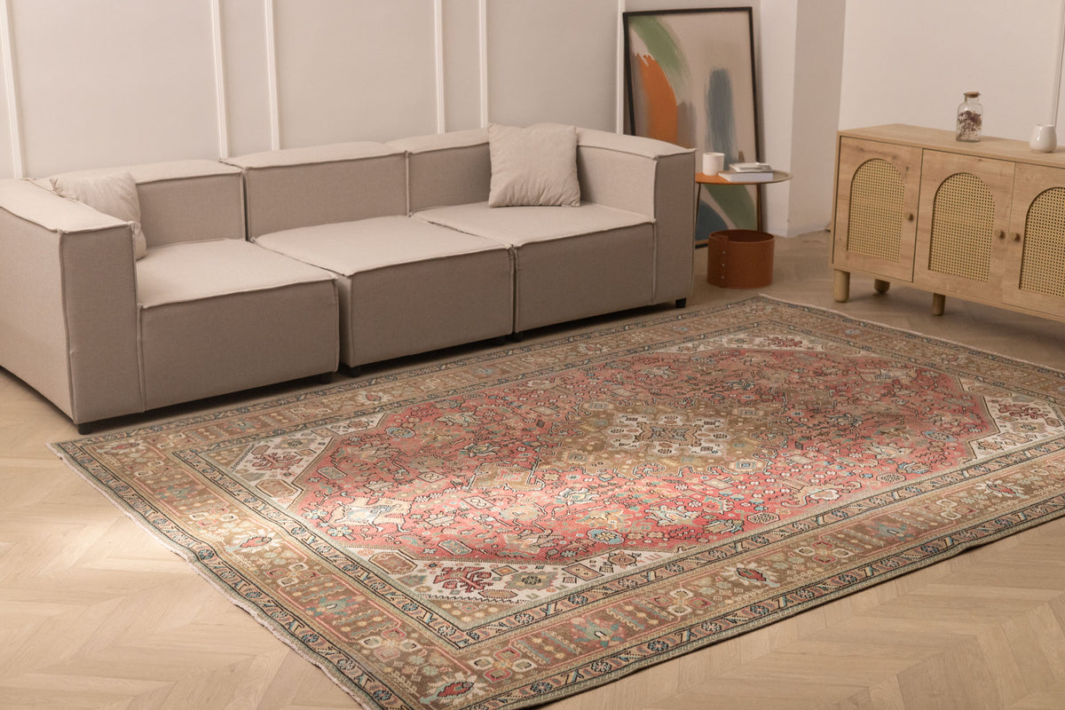 Oversized 7.7x11 ft Persian-style wool and cotton rug featuring traditional red and brown floral patterns in a living room.