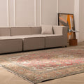 Oversized Persian-style wool and cotton area rug with red and brown floral patterns in a modern living room.