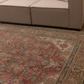 Oversized 7.7x11 ft Persian-style wool and cotton rug in red and brown with traditional floral motifs.
