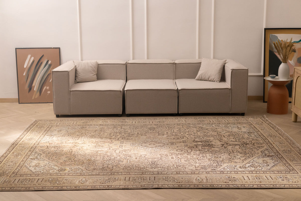 Oversized 7.9x11 ft Persian-style wool and cotton area rug in beige and brown with traditional floral patterns.