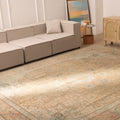 Oversized 9.7x12.5 ft Persian-style wool and cotton rug featuring brown and orange floral patterns in a living room.