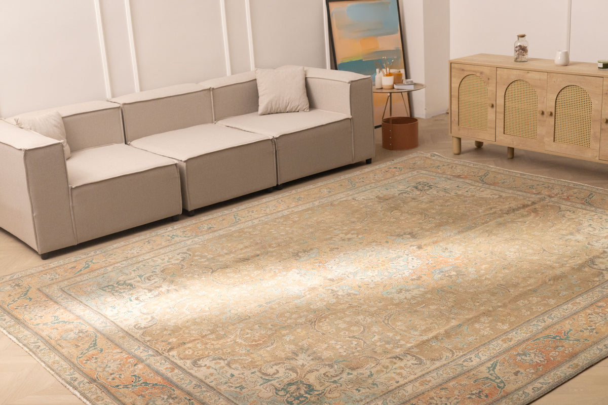 Oversized 9.7x12.5 ft Persian-style wool and cotton rug featuring brown and orange floral patterns in a living room.