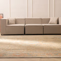 Oversized Persian-style wool and cotton area rug in brown and orange with floral motifs in a modern living room.