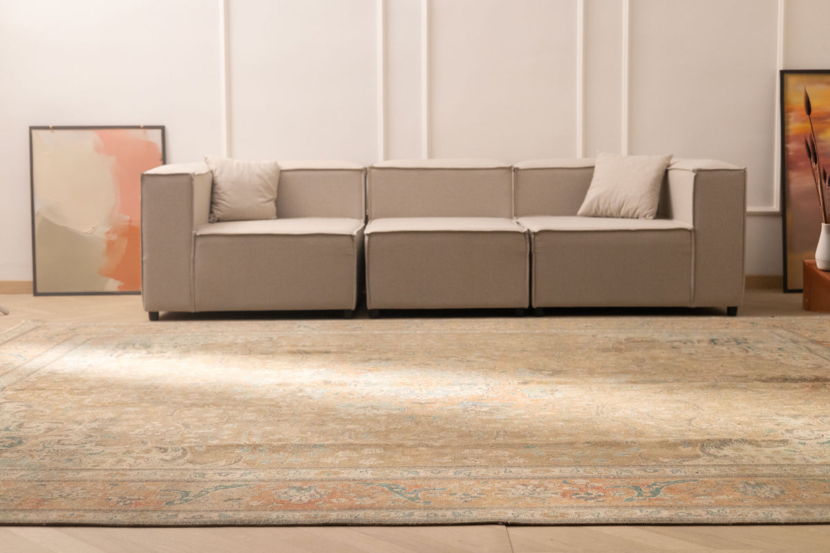 Oversized Persian-style wool and cotton area rug in brown and orange with floral motifs in a modern living room.