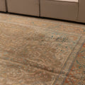Oversized wool and cotton Persian-style rug in brown and orange with floral motifs and maximalist patterns.