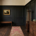 Beige Persian runner rug in a den