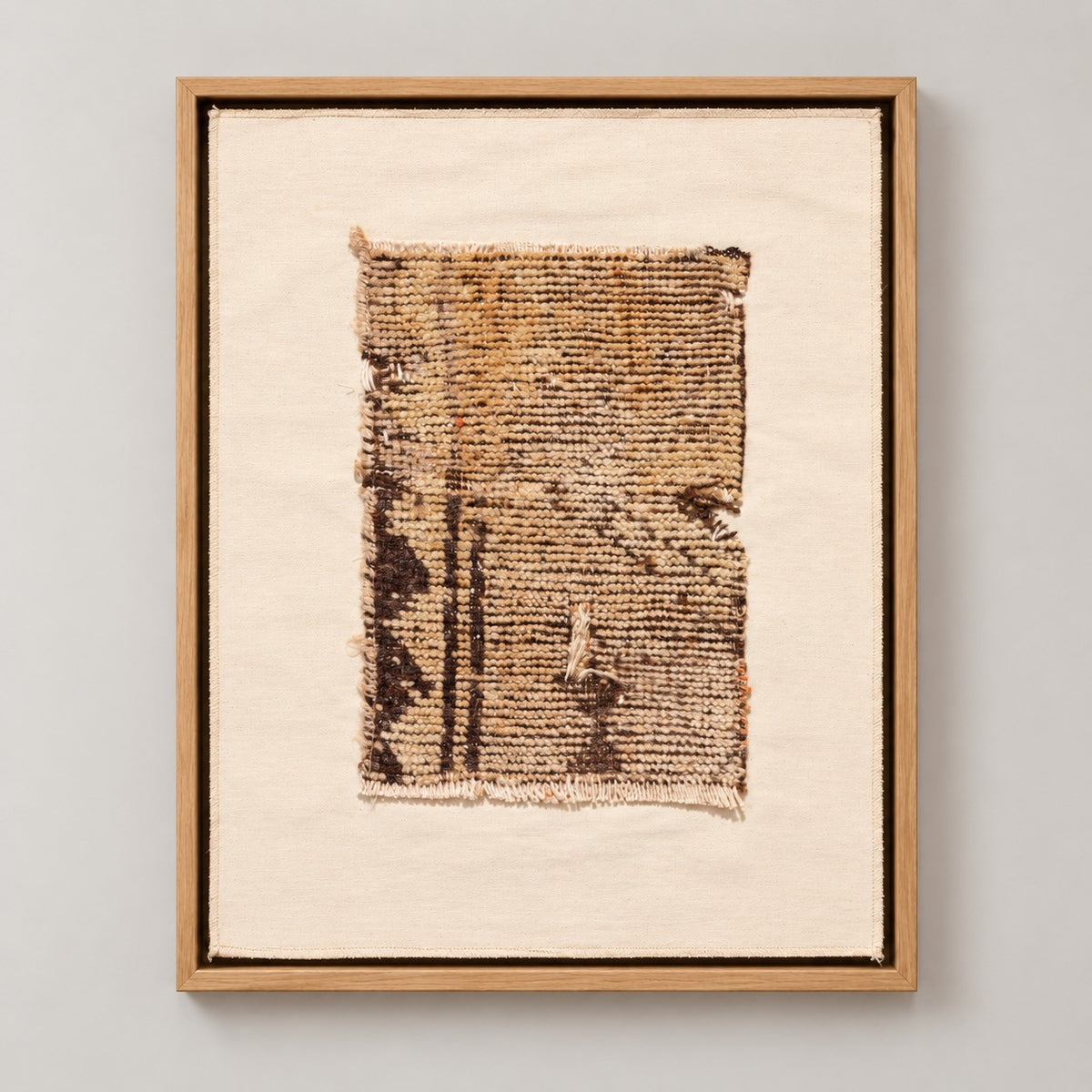 Framed vintage rug fragment wall art in brown, gold, ivory