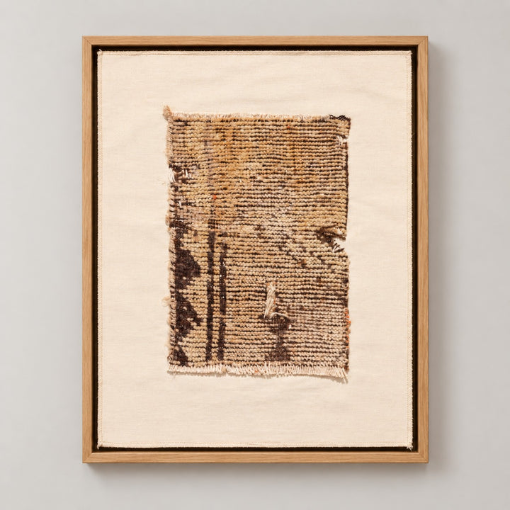 Framed vintage rug fragment wall art in brown, gold, ivory
