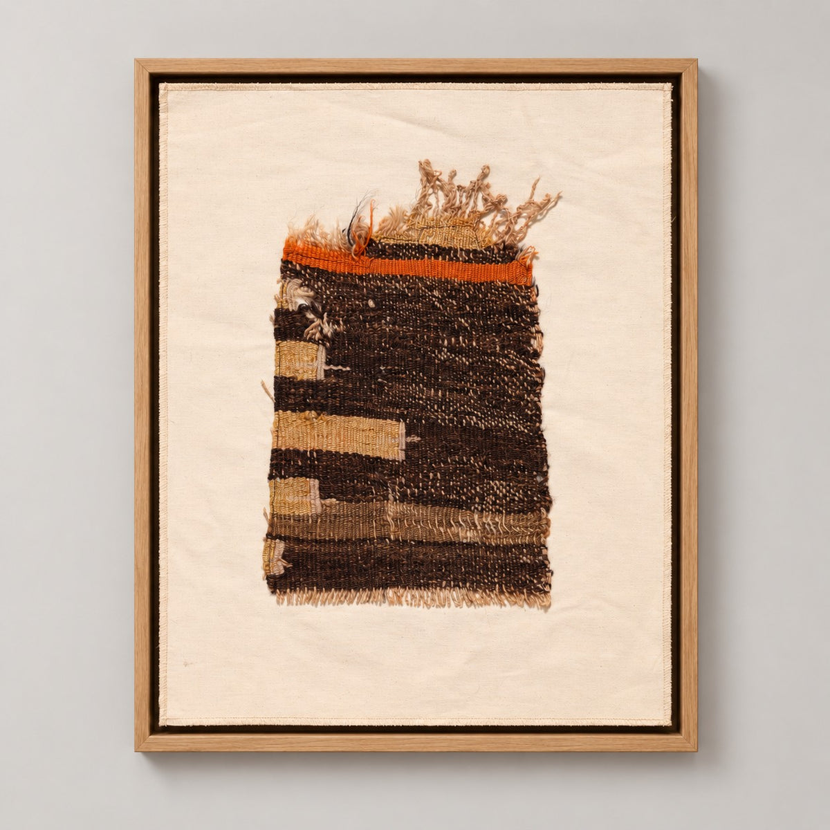 Framed vintage kilim fragment wall art in dark brown, cream, orange