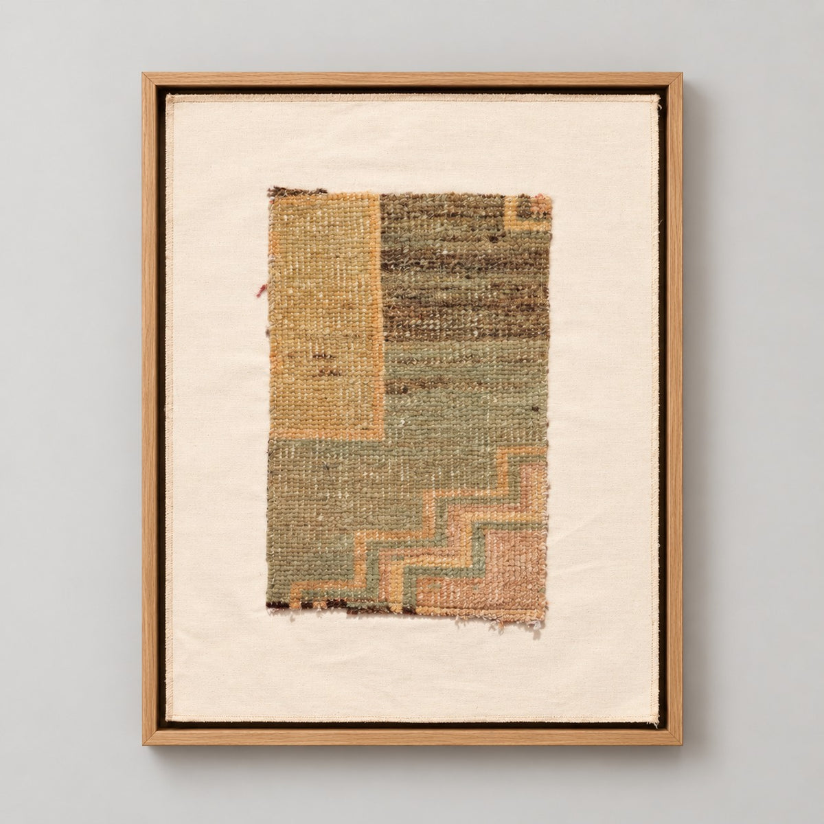 Framed vintage rug fragment wall art in sage, mustard, dusty rose