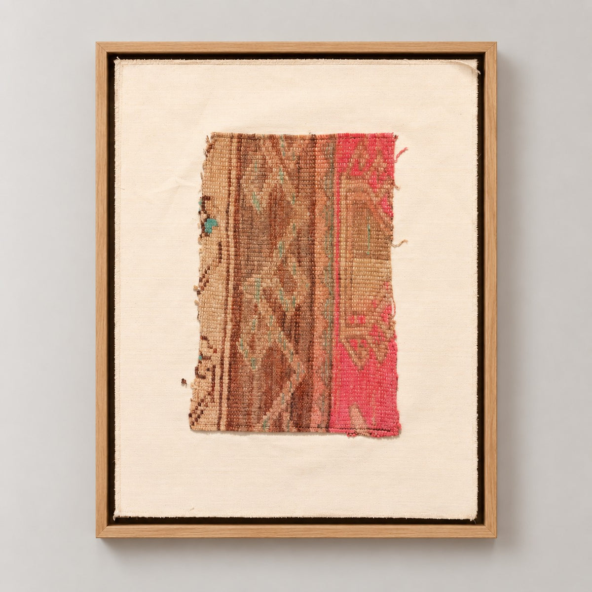 Framed vintage kilim fragment wall art in brown, tan, pink