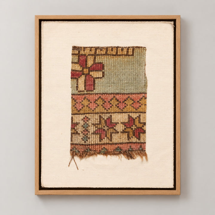 Framed vintage rug fragment wall art in pale green, rust, mustard