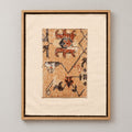 Framed vintage rug fragment wall art in apricot, rust, navy, black