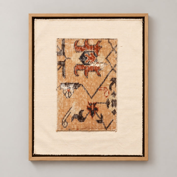 Framed vintage rug fragment wall art in apricot, rust, navy, black