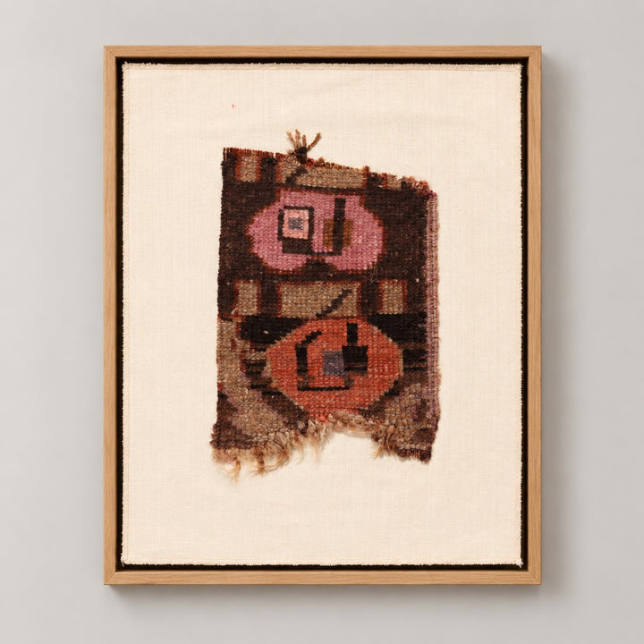 Framed vintage rug fragment wall art in dark brown, pink, orange