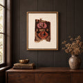 Framed vintage rug fragment wall art in dark brown, pink, orange hanging on a dark wall above a wooden console