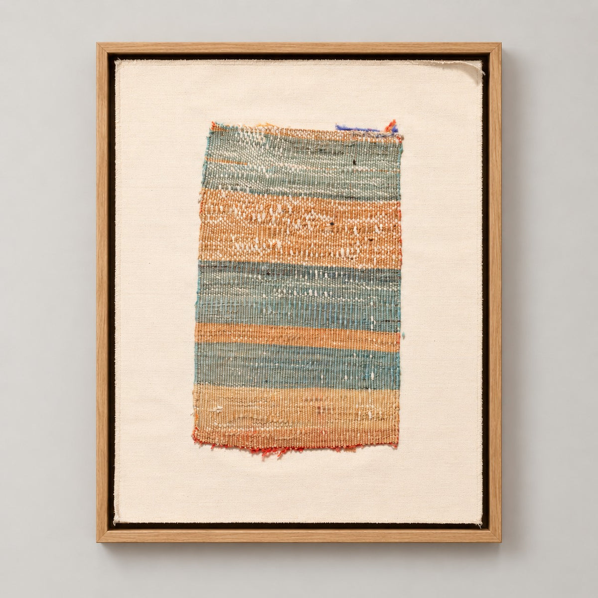 Framed vintage kilim fragment wall art in aqua, sand, rust
