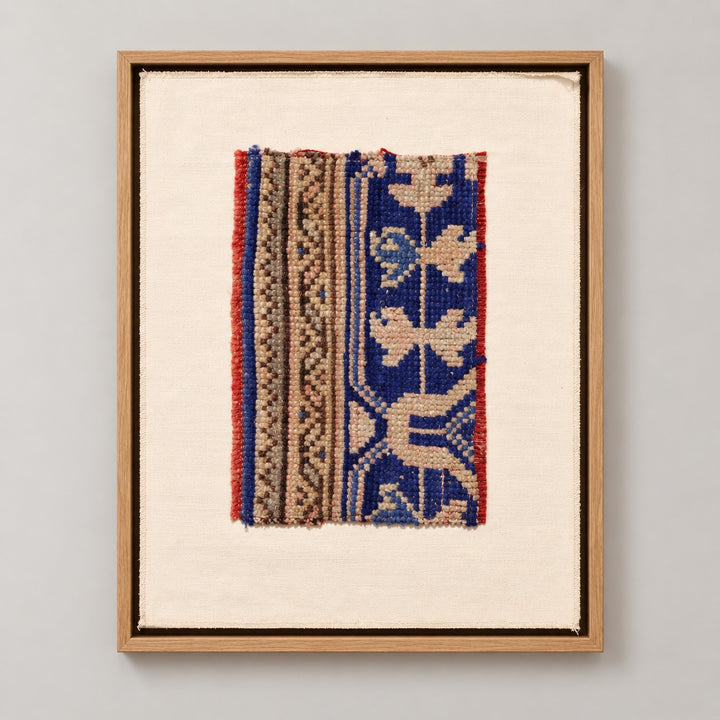 Framed vintage rug fragment wall art in cobalt blue, tan, red