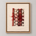 Framed vintage rug fragment wall art in red, ivory, black