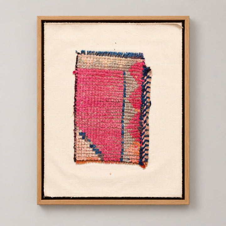 Framed vintage rug fragment wall art in hot pink, navy, beige