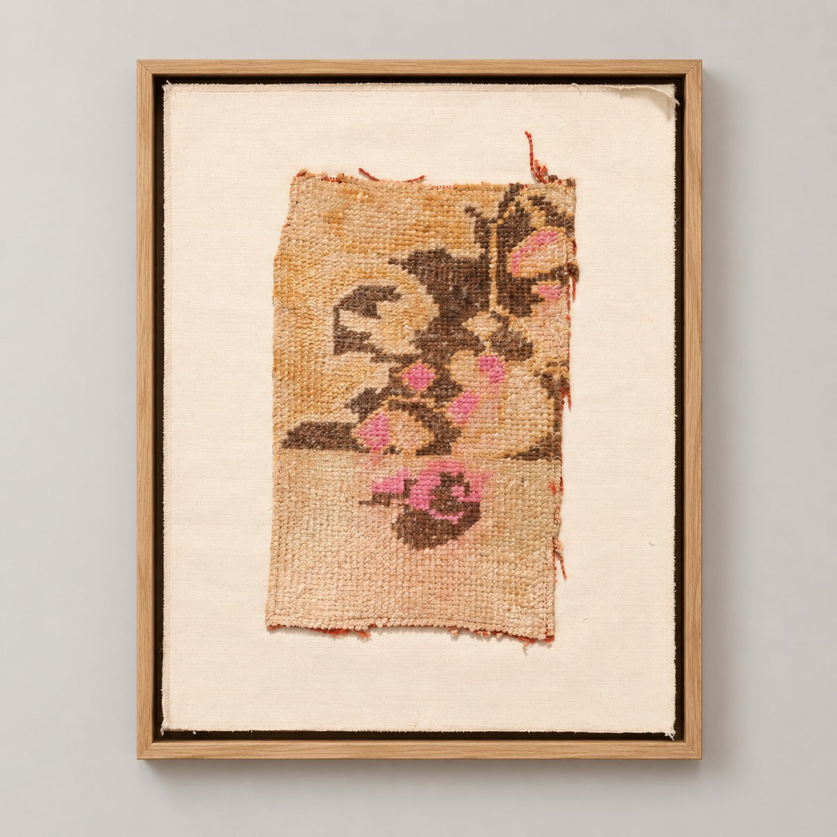 Framed vintage rug fragment wall art in apricot, brown, pink